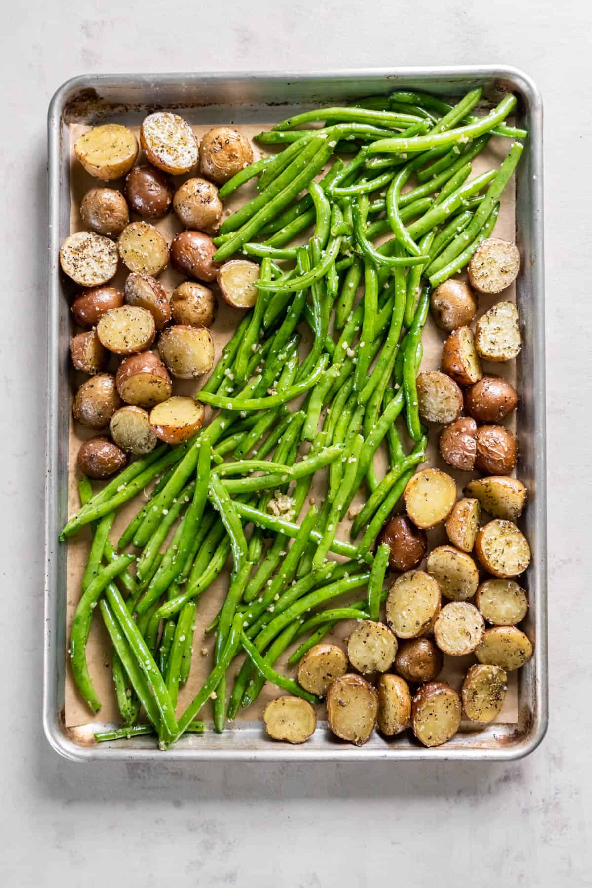 Mixed vegetables on a sheet pan ready for baking.