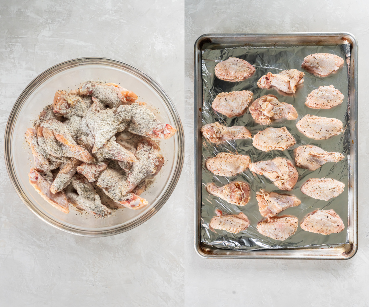 Raw chicken wings sitting in a large bowl with the seasonings and baking powder on top before mixing together and arranging on a baking sheet for baking.