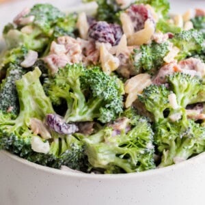 Broccoli Crunch Salad in a white bowl on a countertop ready for serving.