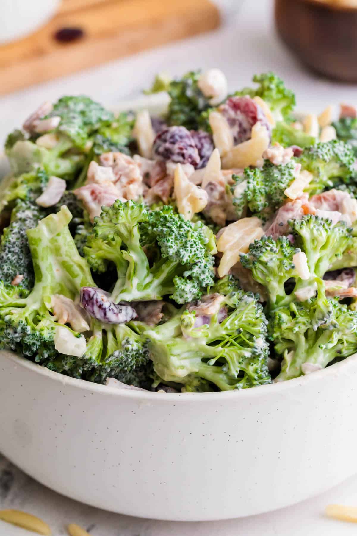 Broccoli Crunch Salad in a white bowl on a countertop ready for serving.