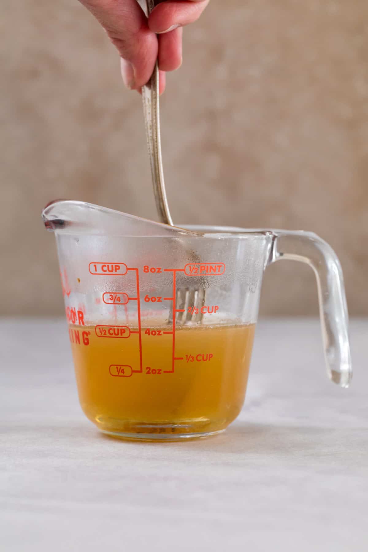 A photo of the honey being mixed together with the warm water. 