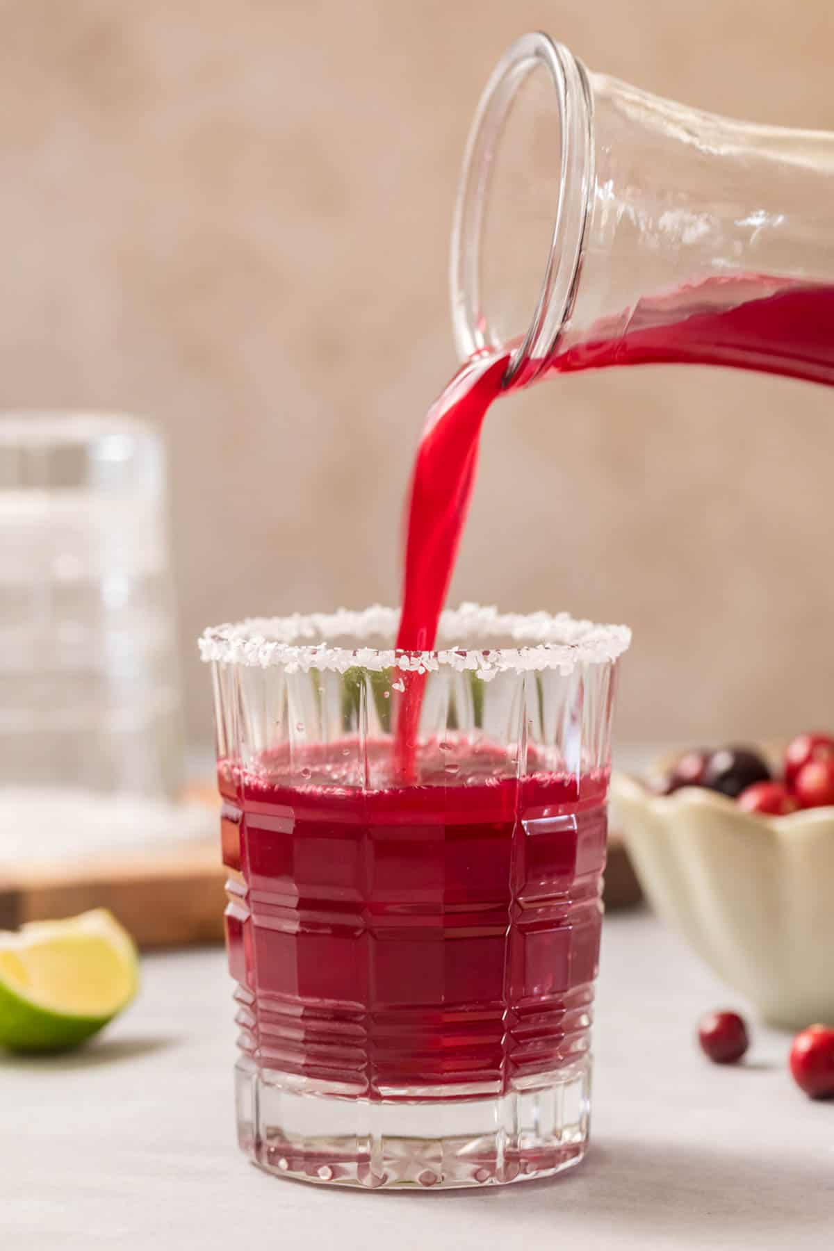 Pouring the mocktail into a glass for serving. 