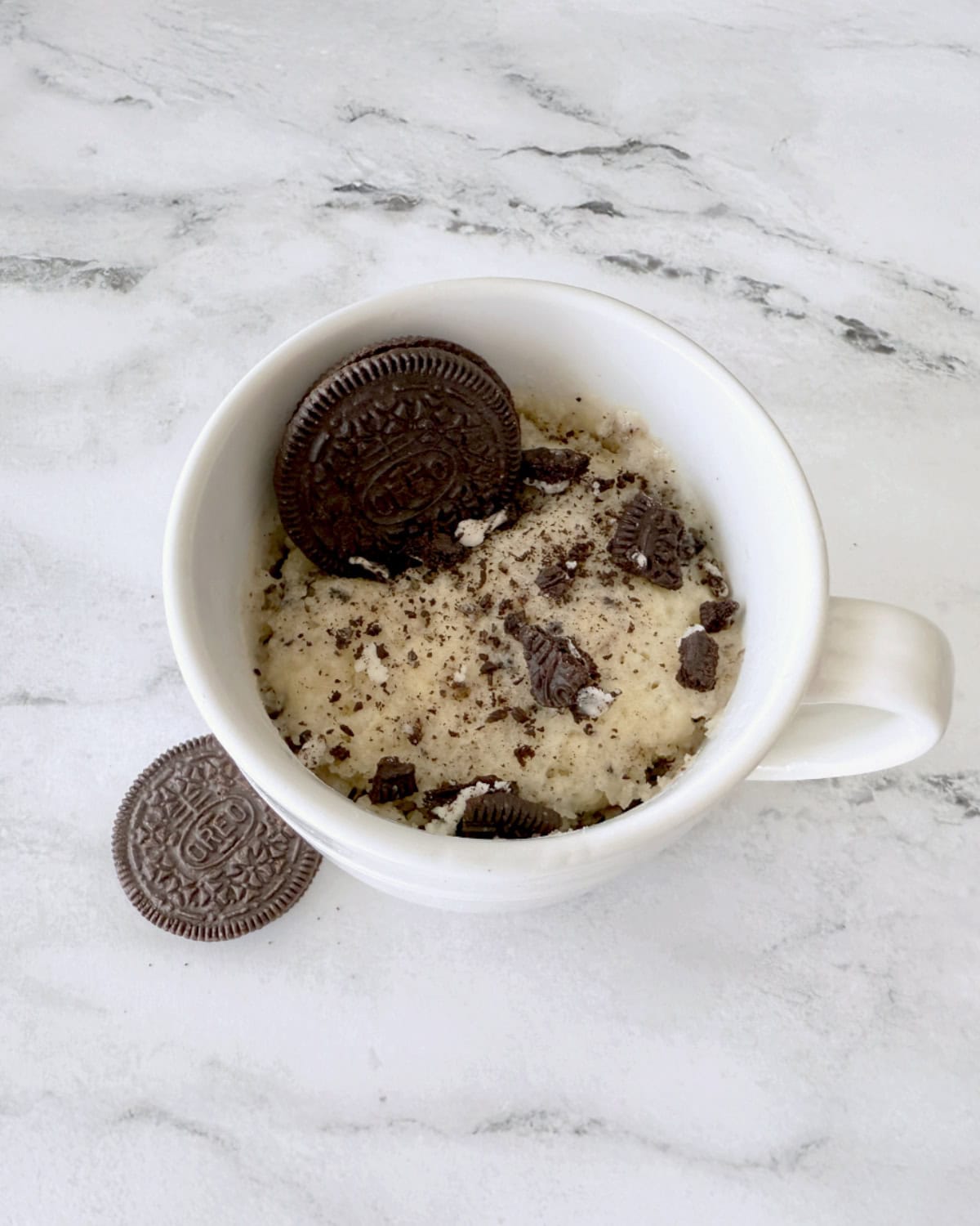 Overhead view of a mug with cake in it.